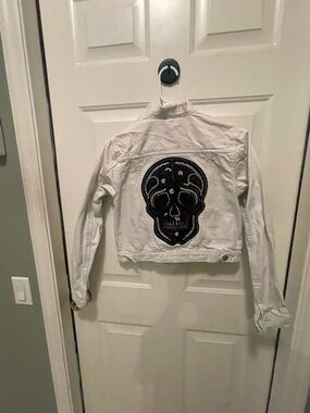 a new day White Jean Jacket with Black Skull Patch
